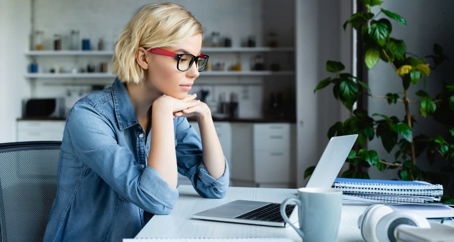 Young professional using laptop computer in home workspace